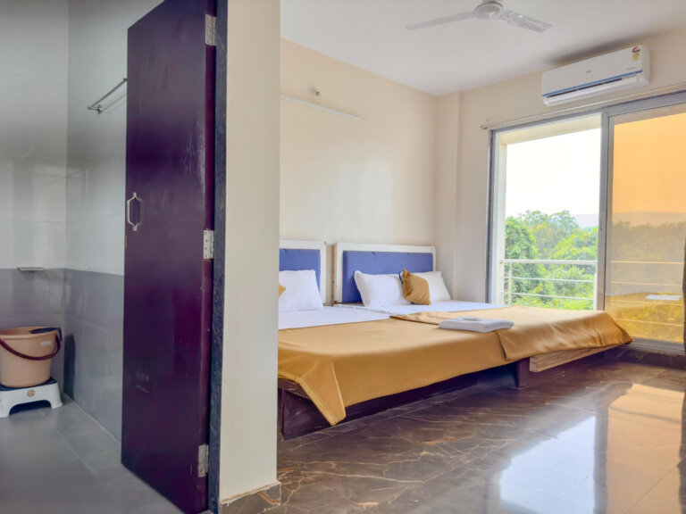 Two-bed room with balcony doors at NB Nature Stay